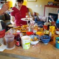 waffle party guests piling on toppings