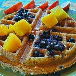 naked gluten-free vegan waffle with blueberries, mango, maple syrup