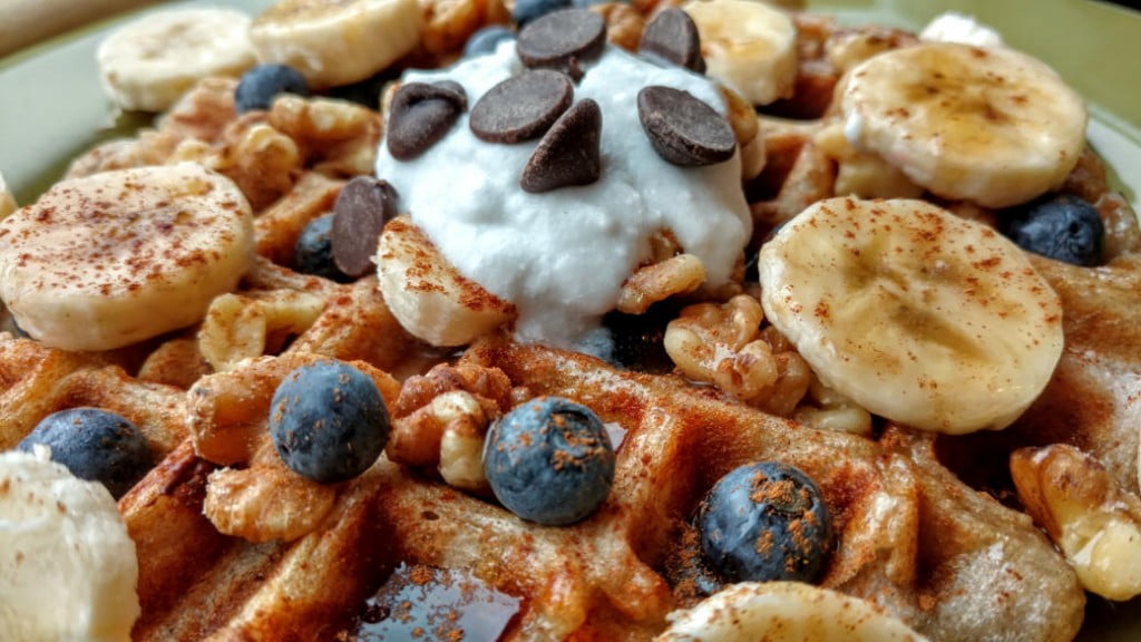 vegan sourdough waffles with blueberries, coconut cream, chocolate chips, side closeup
